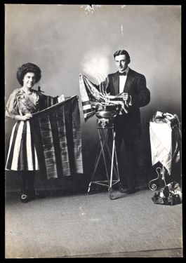 Magician and His Assistant Producing Flags