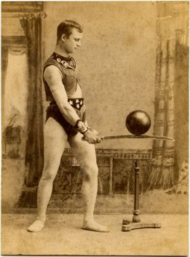 Magician Balancing Cannonball Card Photograph